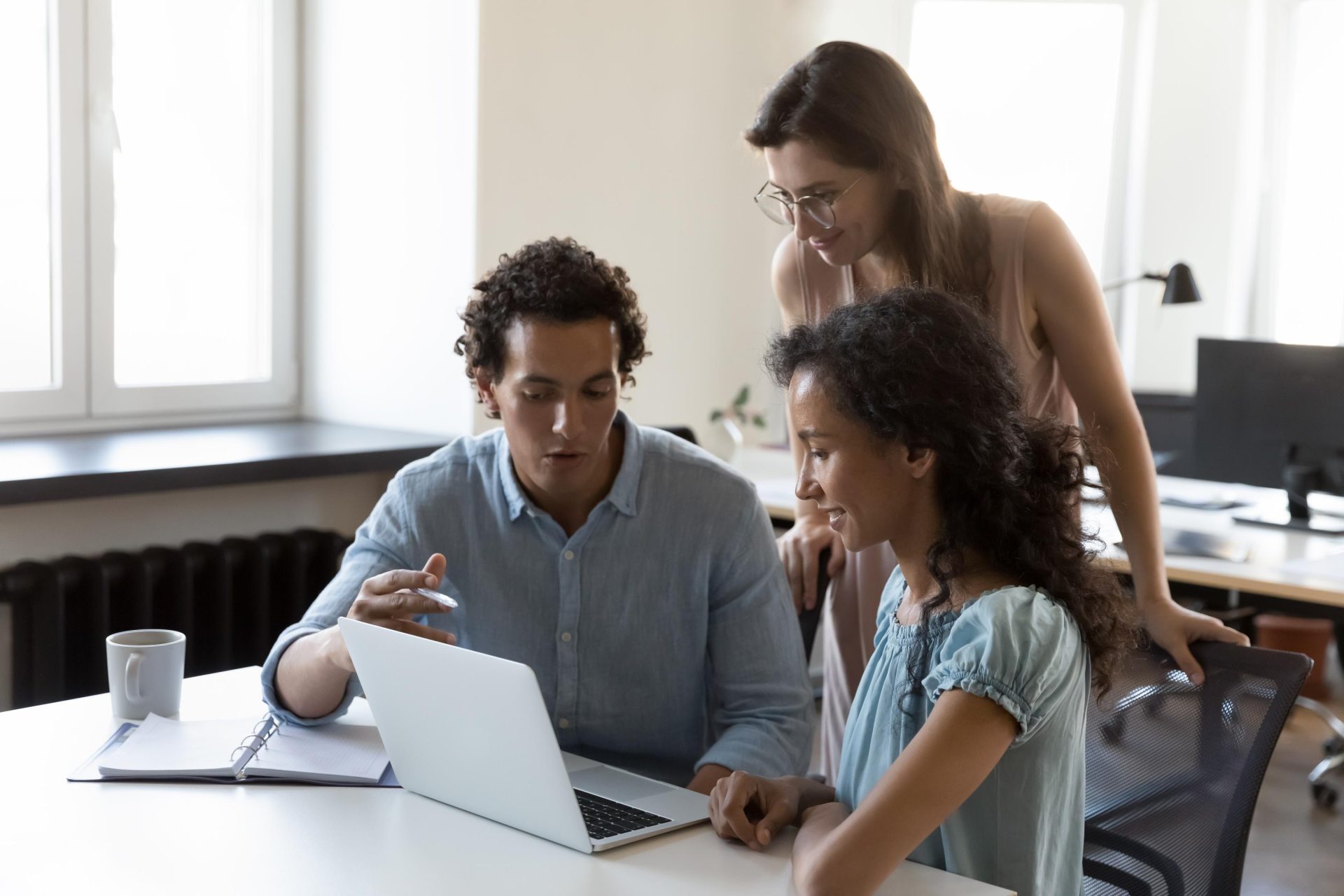 3 professionals working together on Laptop